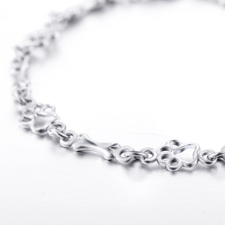 Zilveren armband met hondenpoot- en botbedeltje